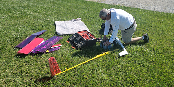 Rick Bothell assembling his airplanes in the morning.