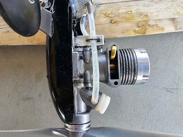 A bottom view of the K&amp;B 40 engine with shutoff and primer tube installation for instant restarts.