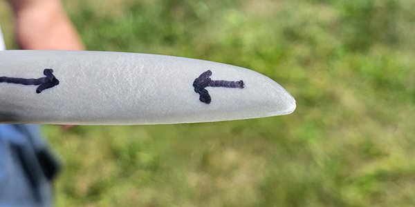 The author noticed that this propeller on a competitor’s airplane had tiny &quot;check cracks&quot; along one of the blades, likely incurr