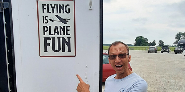 Lynn showing signage in his trailer.