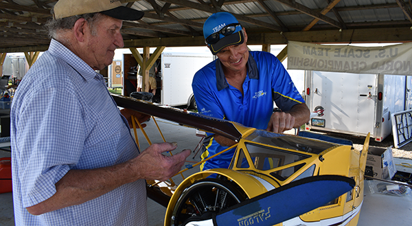 :] Tim Dickey, assisted by Jack Buckley, assemble the Romania-bound FAI F4C Waco Cabin.