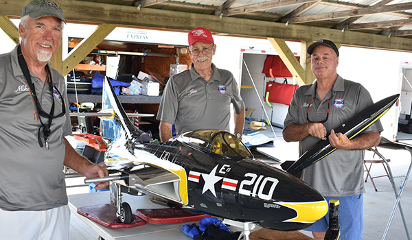 A team effort is required to assemble Mike Wolvin’s (M) F9F Cougar. Assisting Mike is Jim McDevitt (L) and Steve Cohen (R).