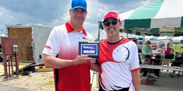 Jason (L) being presented his fifth-place award by Doug (R).