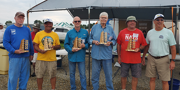 Competitors in Andrade Rubber with their trophies made by Paul.