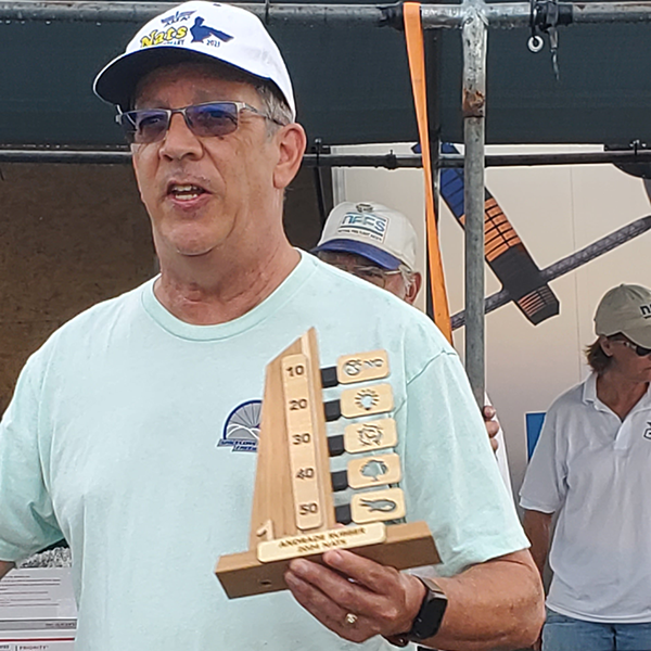 :] Paul Andrade holding the trophies that he made for all fliers in Andrade Rubber.