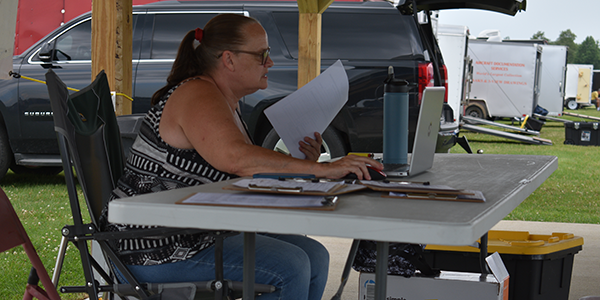 Scorekeeper Jan Merenberg’s job this weekend is just beginning as she adds registered pilot data into the scoring program.