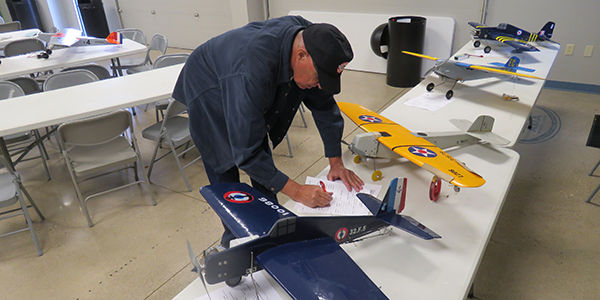 Burt Brokaw filling out processing paperwork.