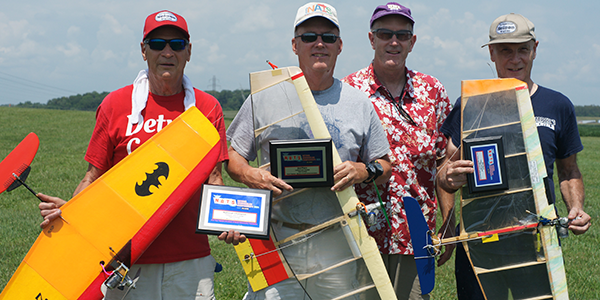 The 2024 Fast Combat winners (L-R): Steve Kott, first; Brian Stas, second; Event Director Dave Edwards; and Craig Campbell, thir