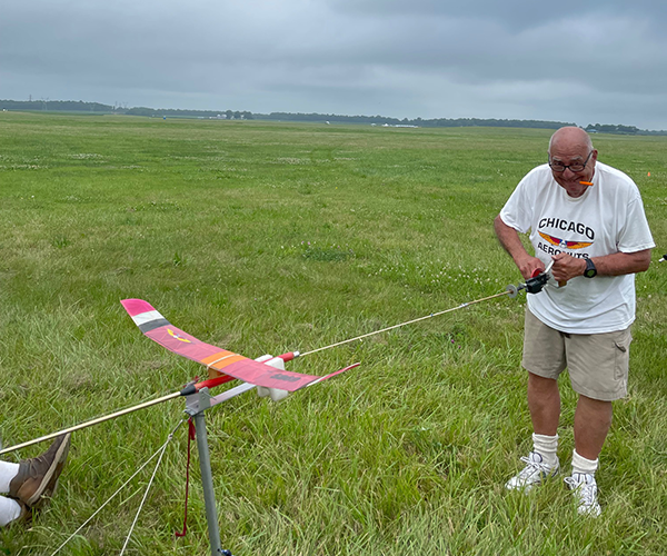 Chuck Markos prepares for competition by winding his model.