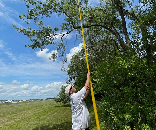 Don uses a 50-foot pole to retrieve a model.