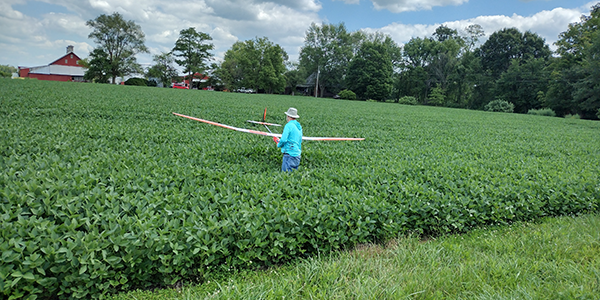 John recovering his sailplane from the bean field after landing four miles into the XC course.