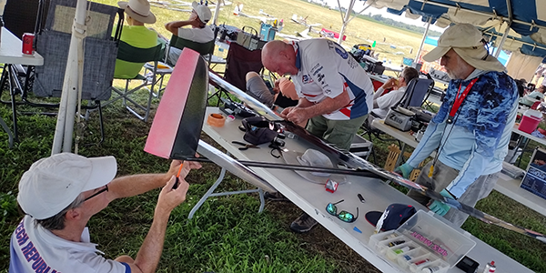 Teamwork repairs between rounds. Gordon Buckland broke a wing joiner in a midair and had to do some quick surgery to fix it.