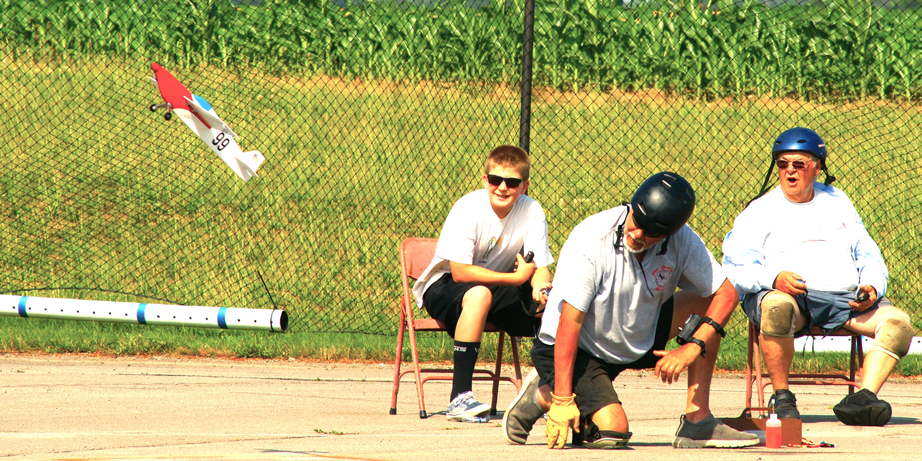 Timers Tristan Mayer (left) and Bob Oge are surprised by the vertical takeoff when the model is released by Richard Kucejko. The