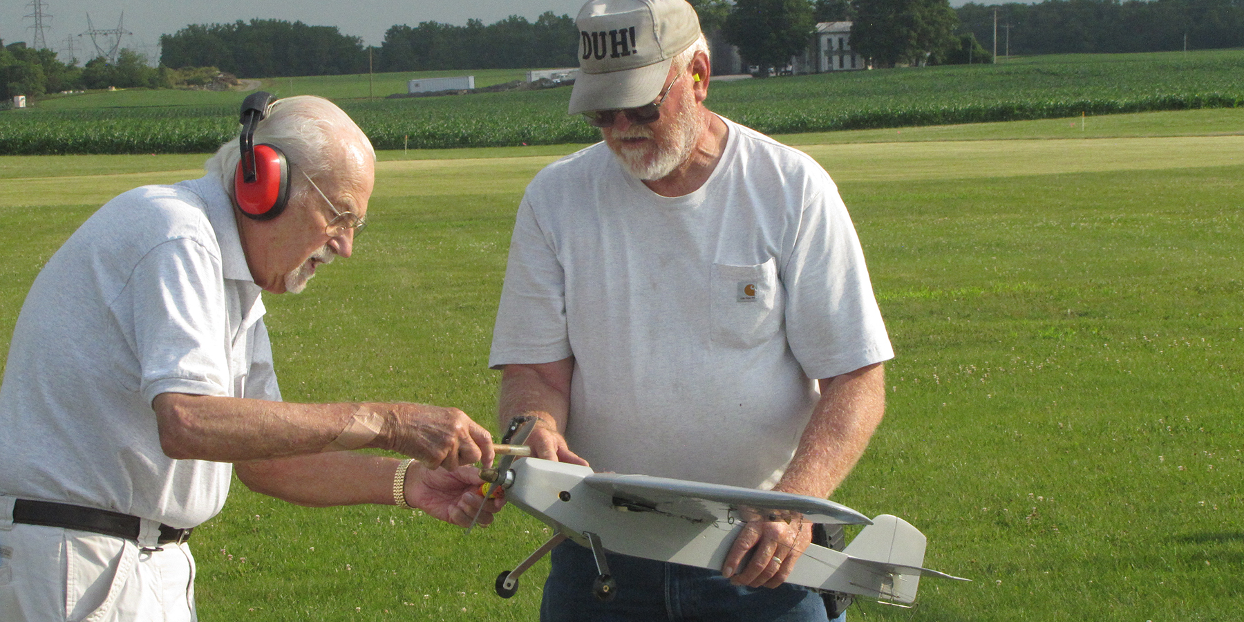 Melvin Schuette holds Pete Mazur’s MO-1 as he starts the engine. The camaraderie among Carrier flyers is one of the more enjoyab