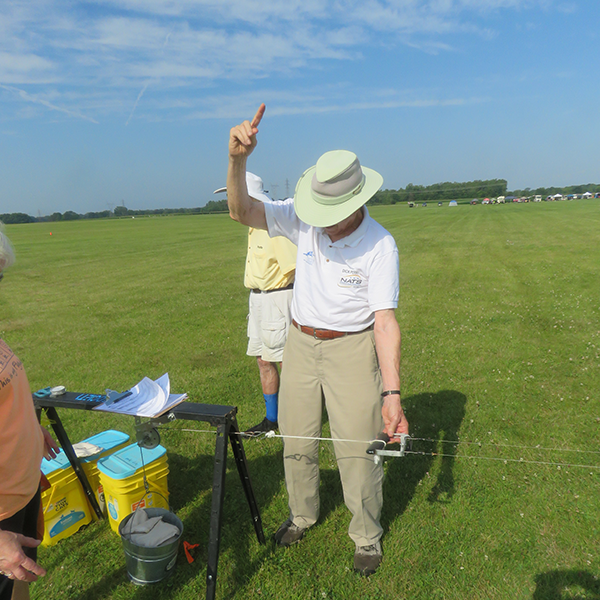 Event Director Dick Perry is ready to signal the completion of a model’s pull test.