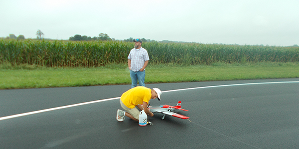 Todd Lee preparing his airplane to fly a warm-up flight for the judges.