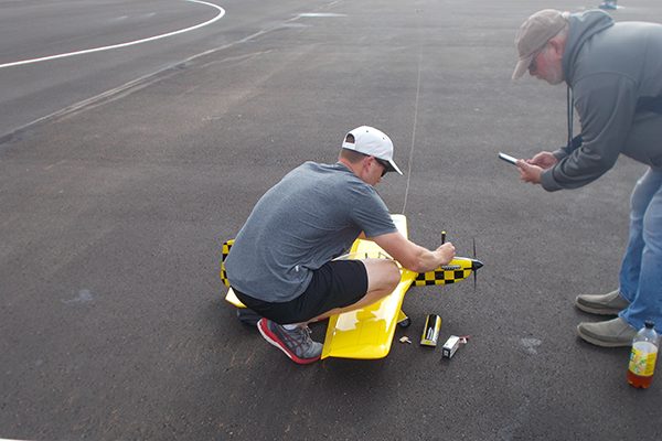 Mike Palo readies his airplane for a flight in the pits.