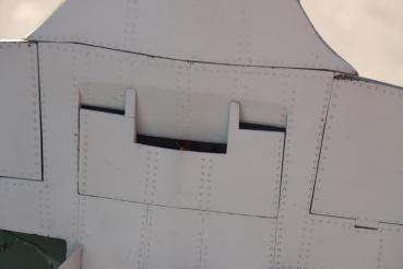 The access hatch is installed, covering the wing attach bolts, air fill valve, and electric-powered arming plug.