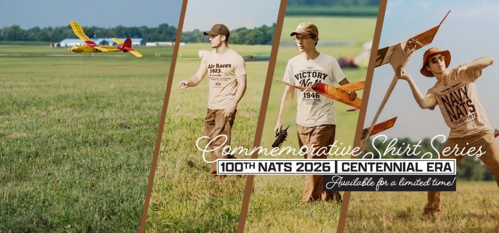 Model airplane enthusiast in field with planes, wearing a commemorative shirt.
