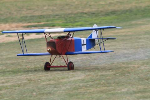 Dale Arvin’s Balsa USA Fokker DVII lifts the tail on a takeoff run down the runway. (2022)