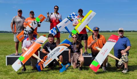 Your podium finishers (front row L to R) Jason Duda - 5th place, Dominic Del Ponte - Best Junior, Annabelle Doe - Best Senior, Pilot A.J. Seaholm and caller Lonnie Smith - 4th place. (Back row L to R) caller Ray Brown and pilot Dean Stone - 3rd place, Matthew Fehling and caller Jacob Raquet - 1st place and 2nd place, respectively.