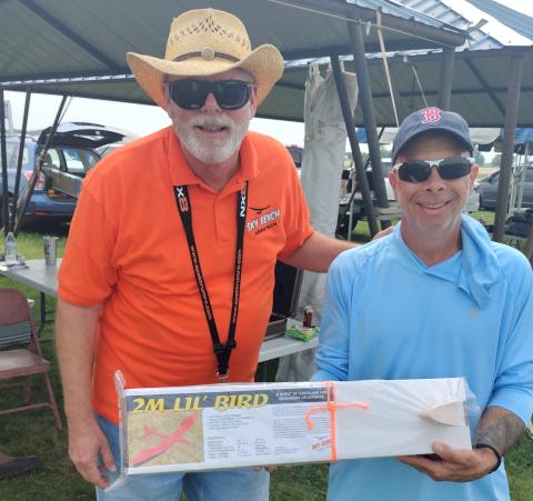 Scott Black of Sky Bench Aerotech presents raffle winner, Fred Maier, with a Little Bird.