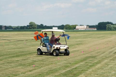George Pritchett and Tim Gillow utilizing the golf cart to retrieve their GNATs.