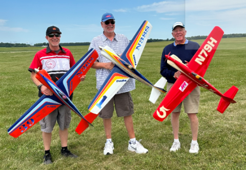 This represents some of the icons in the Pylon community. On the left, Travis Flynn is holding Dave Shadel’s long wing Kaze, which was built and painted by Jim Shinohara. In the middle, Lee VonDerHey is holding Ron Schorr’s long wing Kaze. On the right is Mike Helsel holding his long wing Kaze.