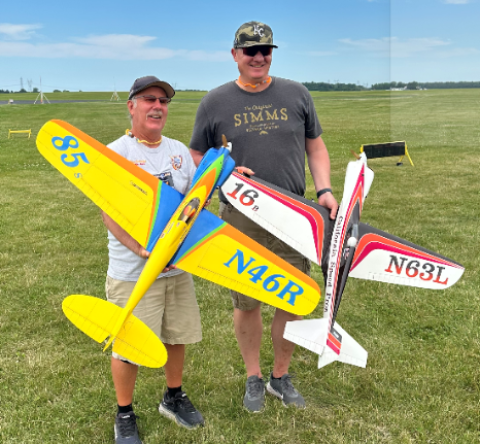More iconic airplanes and pilots. Brian Richmond is holding his Denight Special, which was built and painted by his brother Bruce Richmond. AJ Seaholm is holding Lyle Larson’s shark.