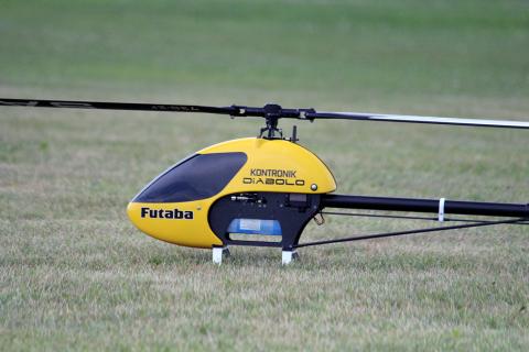 black and yellow rc helicopter on the ground
