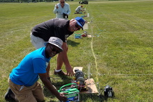 Charles Thomas, Contest Director Wally Adasczik, and Bob Burson setting up the winch lines Friday afternoon for the weekend’s Quadfecta competition.